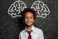 Clever child. Little school boy student on chalkboard background with big brain and science formulas Royalty Free Stock Photo