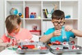 Clever children creating diy construction at the table. Happy boys playing with metal constructor