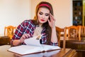 Clever female student hair ponytail girl sitting in library with books.