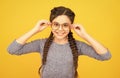 Clever girl. Girl school pupil wear eyeglasses yellow background. Adorable nerd. Schoolgirl concept. Smart girl bad