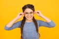 Clever girl. Girl school pupil wear eyeglasses yellow background. Adorable nerd. Schoolgirl concept. Smart girl bad