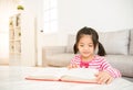 Clever girl at table with reading books