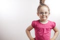 Clever kid with hairbun posing to the camera Royalty Free Stock Photo