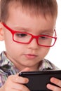 Clever kid is playing with smart cell phone