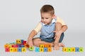 Clever little boy with blocks on the floor Royalty Free Stock Photo