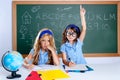 Clever nerd student girl in classroom raising hand