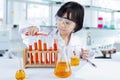 Clever school girl experimenting chemical liquid Royalty Free Stock Photo