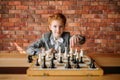 Clever schoolgirl, chess player at the table