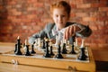 Clever schoolgirl, chess player at the table