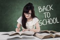 Clever student back to school writes on the books Royalty Free Stock Photo