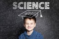 Clever student child on blackboard background with formulas