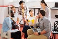 Clever students sitting in circle and talking about their project