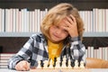 Clever thinking child. Chess for intelligent kid. Child genius, smart pupil playing logic board game. Clever school boy Royalty Free Stock Photo