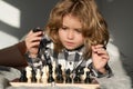 Clever thinking child. Clever concentrated and thinking kid playing chess. Kids brain development and logic game. Royalty Free Stock Photo