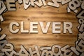 CLEVER word made with block letters lying on wooden board