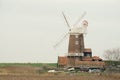 Cley windmill standing beside the marsh. Royalty Free Stock Photo