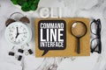 CLI Command Line Interface text with alarm clock and magnifying glass on marble background Royalty Free Stock Photo