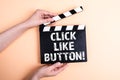 Click like button. Female hands holding movie clapper Royalty Free Stock Photo