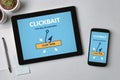 Clickbait concept on tablet and smartphone screen