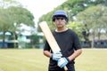 Clicket players hold bats in hand while practicing on the field. Royalty Free Stock Photo