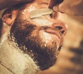 Client during beard shaving Royalty Free Stock Photo