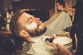 Client during beard shaving Royalty Free Stock Photo