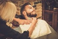 Client during beard shaving Royalty Free Stock Photo