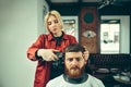 Client during beard shaving in barber shop Royalty Free Stock Photo