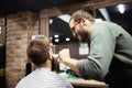 Client during beard shaving in barber shop Royalty Free Stock Photo