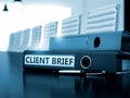 Client Brief on Office Folder. Blurred Image.