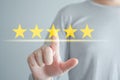 Client click on five yellow stars to increase rating. Customer Experience, Satisfaction, Feedback, Review, Evaluation concept. Royalty Free Stock Photo