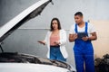 A mechanic consults with a client about a car repair Royalty Free Stock Photo