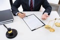 Client with his partner lawyers or attorneys discussing discussing a document or contract agreement working at table in office, Royalty Free Stock Photo