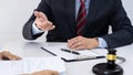 Client with his partner lawyers or attorneys discussing discussing a document or contract agreement working at table in office, Royalty Free Stock Photo