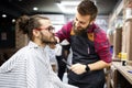 Client during beard shaving in barber shop Royalty Free Stock Photo