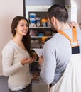 Client and repairman near fridge Royalty Free Stock Photo