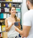 Client at shop paying at cash register desk