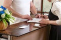 Man welcoming young woman client at office reception desk Royalty Free Stock Photo