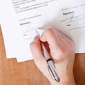 Client signs an agreement by silver pen Royalty Free Stock Photo