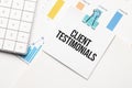 Client Testimonials text concept. Office workplace table with calculator, graphs, reports and the text Budget 2021 on a small Royalty Free Stock Photo