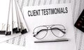 CLIENT TESTIMONIALS text on paper with chart and office tools , business concept Royalty Free Stock Photo