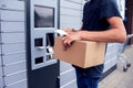 Client using automated self service post terminal machine or locker to deposit a parcel for storage