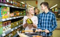 Clients buying tinned food Royalty Free Stock Photo