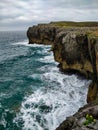 Cliff on the coasts of Asturias, in northern Spain, with the revolted sea Royalty Free Stock Photo