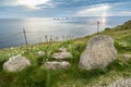 Cliff edge boulders and shafts of sunlight shining through clouds at sunset,Land`s End,Cornwall,England,UK Royalty Free Stock Photo