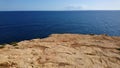 Cliff Edge Overlooking the Deep Blue Sea Royalty Free Stock Photo