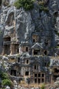 A cliff face covered in Lycian rock-cut tombs at the ancient site of Myra at Demre in Turkey. Royalty Free Stock Photo