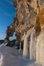 Cliff with a hole like a heart covered with ice splashes