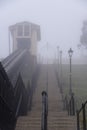 Cliff Lift funicular railway rising up cliff gardens on a cold, foggy frosty morning