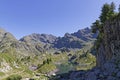 Cliff over the green mountain lake, Lac Longet Royalty Free Stock Photo